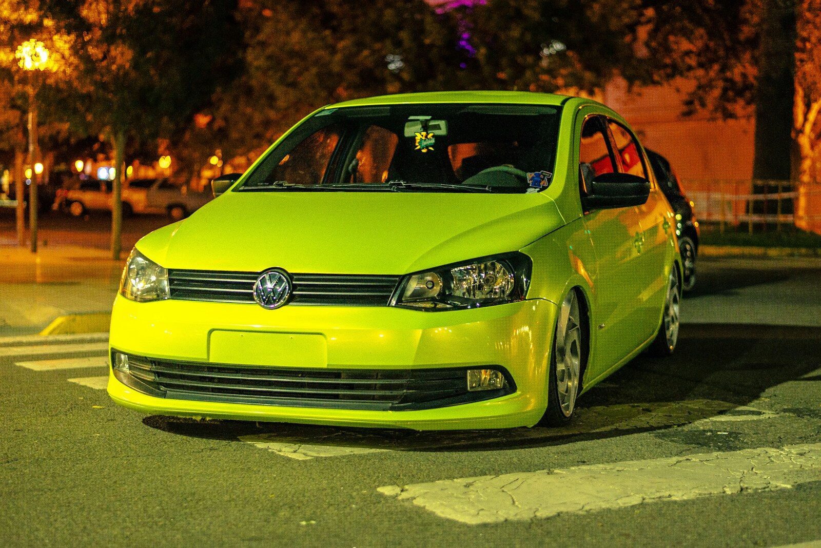 Bright yellow car parked on a road.